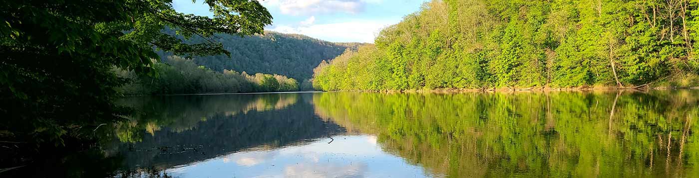 lake reflecting forest and mountains in Preston County West Virginia
